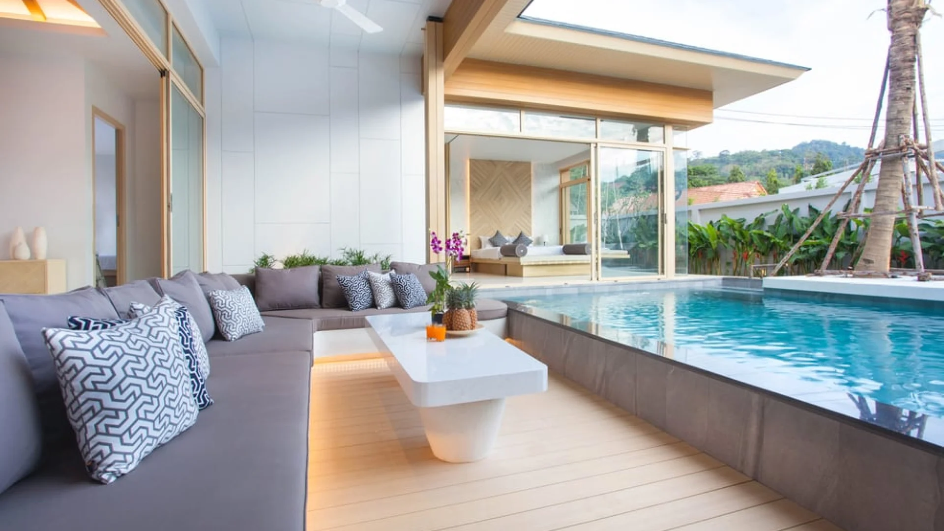 A semi-ground pool with coping for safety and seating, providing an infinity pool view, installed by a professional swimming pool builder in Malaysia.