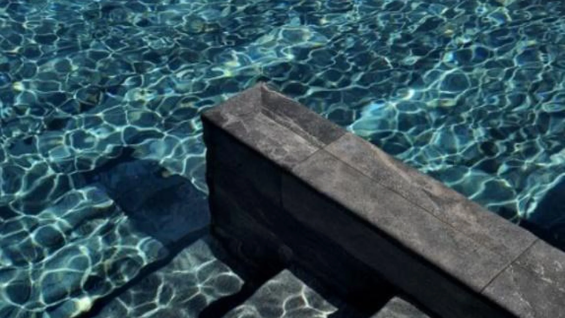 Pool lined with natural stone or granite finish.
